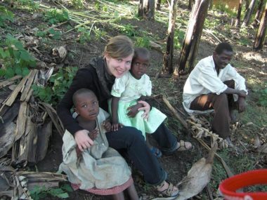 Children having a light moment with a donor together with a caregiver Children having a light moment with a donor together with a caregiver